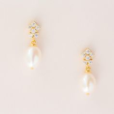 ELLA // Freshwater pearl drop earrings - Petite and delicate, perfect for adding a touch of sophistication. A beautiful blend of classic pearls and sparkling clusters of cubic zirconia. Materials: 14k gold/silver plated brass, cz stones, freshwater pearls Length: 2cms Your jewellery comes beautifully packaged. Please note, that for hygiene reasons earrings cannot be returned. Delicate Yellow Gold Bridal Earrings With Pearl Drop, Dainty Yellow Gold Pearl Earrings For Wedding, Dainty Yellow Gold Pearl Wedding Earrings, Yellow Gold Pearl Charm Bridal Earrings, Wedding Yellow Gold Pearl Charm Bridal Earrings, Yellow Gold Bridal Earrings With Pearl Charm, Yellow Gold Pearl Bridal Earrings For Wedding, Delicate Yellow Gold Bridal Earrings For Wedding, Elegant Gold Pearl Earrings For Wedding