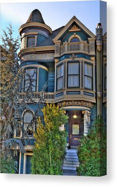 an old victorian style house with many windows and balconies