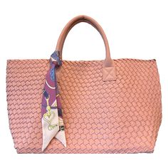 Woven Vegan Leather Tote! This luxurious woven tote is made from a premium performing alternative to leather, each bag is hand-woven by artisans. Th tote includes double reinforced top handles and tie straps inside to adjust bag size, as well as a detachable zipper pouch. Perfect for use as a on-the-go tote or a shoulder bag for everyday wear.   Water resistant material will not stain, bag is not water proof due to open weave of the material. Dimensions: 16" wide x 11" high x 7.5" deep Top Handl Luxury Satchel With Braided Handles For Travel, Luxury Woven Bags For On-the-go, Pink Woven Leather Tote Bag, Pink Tote Bag With Woven Leather, Pink Woven Leather Bags For Summer, Summer Pink Woven Leather Bags, Pink Woven Leather Tote Shoulder Bag, Shopping Bag With Intrecciato Weave And Double Handle, Woven Leather Shopping Bag With Double Handle