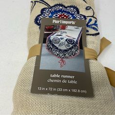 a table runner with an ornament in the middle and a label on it