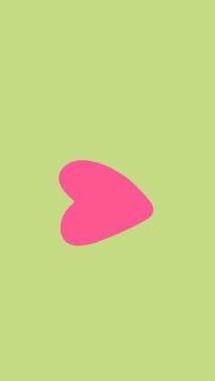 a pink heart on a green background