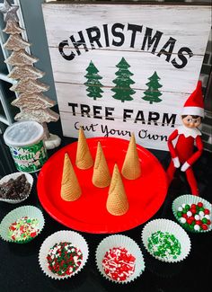 an elf's christmas tree farm is set up with cupcakes and candy