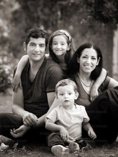 a family posing for a black and white photo