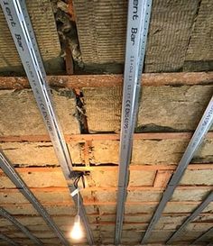 an unfinished ceiling with exposed beams and light bulbs