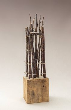 a sculpture made out of branches in a wooden block