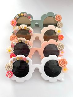 "These personalized boho flower sunglasses are absolutely beautiful! There are many color sunglasses to choose from, and the customization possibilities are endless! Add your child's name, or a cute phrase like \"flower power\", \"sunflower cutie\", \"flower child\", etc. These make a great gift for events, baby showers, photoshoots, sleepovers, birthday girl statement accessories, birthday parties favors, and more! HOW TO ORDER: 1. Choose the color of sunglasses 2. Select your bead color 3. Add Flower Girl Sunglasses, Diy Kids Sunglasses, White Sunglasses With Gradient Lenses As Gift, White Sunglasses With Gradient Lenses As A Gift, Playful Tinted Lens Sunglasses For Festival, White Festival Sunglasses For Summer, White Sunglasses For Summer Festival, Summer Festival White Sunglasses, Personalized Plastic Sunglasses For Beach