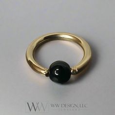 See More: www.WWDesignJewelers.com Contact Us: https://www.wwdesignjewelers.com/policies/contact-informationOur beautiful shiny handmade Captive Bead Black Obsidian Navel Belly Ring is available in 14k solid gold or 14k gold filled or Sterling Silver. Choose between Yellow or Pink Rose Gold or Sterling Silver. This belly ring is comfortable and made from 14 gauge and can be ordered in different diameter sizes - Please request this before purchasing, to make sure the price will remain the same. 14k Yellow Gold Filled Navel Ring is shown in the photos above. This ring can also be used in other piercings, such as the septum, ear or nose. Our 14 gauge 7/16" inch (11.11mm) inside ring diameter is shown in photos.We offer the following types of precious metal:- 14k Solid Yellow Gold - 14k Solid Captive Bead Ring, Septum Hoop, Jewelry Design Inspiration, Navel Ring, Platinum Jewelry, Navel Rings, Belly Ring, Black Obsidian, Belly Rings