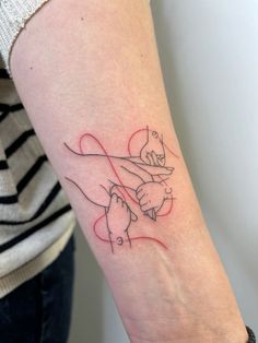 a woman's arm with a tattoo on it that has a hand holding a heart