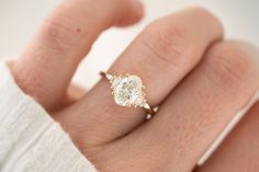 a woman's hand with a diamond ring on it