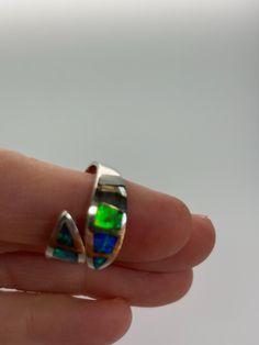 This beautiful inlay opal ring was hand made by a master craftsman, excellent quality, brilliant flashes of opal.  It is one size fits all, just squeeze or pull to tighten or release. Collectible Opal Ring, Opal Inlay Ring Gift, Opal Ring With Inlay Perfect For Gifts, Unique Opal Ring With Inlay For Gift, Oval Opal Ring With Inlay For Gift, Gift Opal Inlay Ring, Collectible Opal Gemstone Ring, Silver Opal Ring With Polished Finish, Unique Collectible Opal Ring