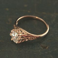 Rose Gold Engagement Ring Oval Solitaire Filigree Ring Aurora Ring Antique Style Ring Vintage Style Ring Hand Cast in our Studio To awaken from true loves first kiss, that is what we remember from Sleeping Beauty. Aurora was the princess' name. This beautiful ring emanates with Victorian style elegance and class. The delicate filigree encases the oval stone of your choice which is held by 6 prongs. The genuine white topaz, white sapphire, cubic zirconia, or moissanite measures 5mm by 7mm. The ri Classic Rose Gold Rings With Intricate Design, Rose Gold Filigree Promise Ring, Rose Gold Rings With Intricate Design, Oval Rose Gold Heirloom Filigree Ring, Elegant Oval Solitaire Engraved Ring, Classic Rose Gold Filigree Ring For Wedding, Elegant Engraved Oval Solitaire Ring, Rose Gold Oval Filigree Ring For Formal Occasion, Formal Rose Gold Oval Filigree Ring