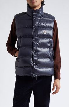 Inspired by '80s archival styles but updated with a modern fit, this lacquered-nylon puffer vest with down fill offers lightweight warmth with an urban look. 25" length (size 2) Front zip closure with snap storm placket Stand collar Side zip pockets Lined, with down fill 100% polyamide Machine wash, dry flat Imported Men's Designer Clothing Down Vest With Padded Collar, Sleeveless Down Vest With Padded Collar, Sleeveless Down Puffer Vest, Fitted Nylon Winter Vest, Casual Nylon Vest With Padded Collar, Casual Fitted Duck Down Puffer Jacket, Fitted Duck Down Puffer Jacket, Winter Sleeveless Down Vest, Winter Down Sleeveless Vest