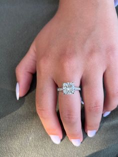 a woman's hand with a diamond ring on it