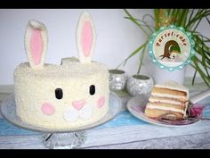 there is a cake with bunny ears on it and a slice of cake in the background