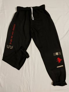 BE YOUR OWN MAIN CHARACTER SWEATPANTS + a surprise matching vinyl sticker. These trendy and unique graphic sweatpants are made on black material with red and gold graphic details. Perfect as a valentines day gift or just treat yourself gift :) I want to create a brand that is a constant reminder to be TRU to who you are as a person; that brings your own unique style into it as well. Life is short, be WHOEVER you want to be! You are your own main character, always. Pair this sweatshirt with whate Casual Black Graphic Print Joggers, Black Casual Joggers With Graphic Print, Black Graphic Print Loungewear Pants, Black Graphic Print Joggers For Streetwear, Black Joggers With Graphic Print For Streetwear, Casual Black Sweatpants With Graphic Print, Hip Hop Style Graphic Print Sweatpants For Loungewear, Hip Hop Sweatpants With Graphic Print For Loungewear, Hip Hop Style Sweatpants With Graphic Print For Loungewear