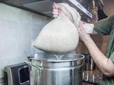 a man pouring something into a large pot