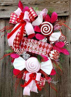 a christmas wreath with candy canes and ribbons