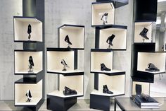 several black and white shelves with shoes in them