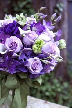 a bouquet of purple flowers sitting on top of a wooden bench with the words, good morning gorgeous