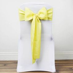 a white chair with a yellow bow on it