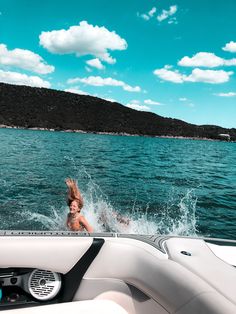 a woman swimming in the water from a boat