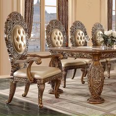 an ornate dining room table and chairs with beige upholstered seats