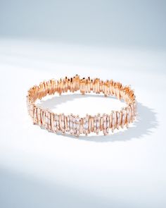 Discover the exquisite elegance of our Classic Gold Half Baguette Milli Bangle, set with 2.80 carats of baguette white diamonds. Crafted with individual segments of 18-karat spring gold wire, this bangle offers unparalleled flexibility and ease of wear. Each diamond is hand-set in Suzanne's distinctive signature style, making this bangle a truly unique statement piece. Details 18k yellow gold or rose gold 2.80 carats of baguette white diamonds 12mm width Ref: AKB207 Elegant Bangle With Baguette Diamonds, Luxury Rose Gold Tennis Bracelet With Baguette Diamonds, Elegant Bangle With Baguette Cut Diamonds, Elegant Baguette Diamond Bangle, Rainbow Sapphires, Tennis Necklace, Classic Gold, Bangle Set, Gold Wire