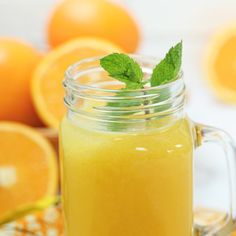 a mason jar filled with orange juice and mint