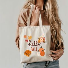 Welcome to my Etsy shop, your destination for cozy and stylish fall tote bags! Embrace the season with my collection featuring charming autumn designs like crisp leaves, pumpkin patches, and warm plaid patterns. Each tote is crafted from high-quality, durable materials to hold all your fall essentials, from market finds to seasonal treats. Whether you're heading to a cozy café or a pumpkin patch, our fall totes combine functionality with festive flair. Discover the perfect accessory to celebrate the season and carry a touch of autumn wherever you go! Fabric: 100% Cotton Canvas Care: Do not iron directly over the printed area - print may stick to the iron.; Spot clean; Do not bleach; Line dry Fall Tote Bag, Fall Tote, Pumpkin Patches, Fall Bags, Seasonal Treats, Cozy Cafe, Fall Essentials, Fall Gifts, Hello Fall