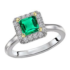 an emerald and diamond ring with two tone gold accents on the shoulders, set in white gold