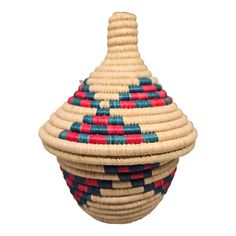 a basket that is sitting on top of a white surface with red, blue and green designs