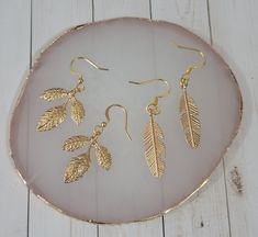 These beautiful earrings come in two distinct designs: one featuring a delicate gold feather, and the other a graceful gold leaf. Both designs are stylish and elegant, with intricate detailing that gives them a realistic and organic appearance. The gold plating adds a touch of luxury and sophistication to both designs, making them perfect for special occasions or for adding a touch of elegance to everyday wear. The lightweight and comfortable design makes them easy to wear all day long, and the Gold Feather Earrings For Party, Gold Feathered Jewelry For Parties, Gold Feather Jewelry For Wedding, Gold Feathered Wedding Jewelry, Gold Feather Earrings As A Gift, Gold Feather Earrings For Gift, Adjustable Gold Feather Earrings, Gift Ideas Birthday, Gold Feathers