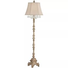 a floor lamp with a white shade on it