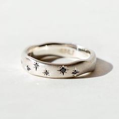 This ring was inspired by the deepest hues of the night sky with 8 black diamonds, scattered along the front length of the band, star-set in a constellation. The brushed texture and wide band make it a perfect ring for everyday wear or in a wedding set. Details Handmade in Philadelphia Brushed Sterling Silver Available with White Diamonds or in 14k Gold. (8) 1mm Black diamonds Wide Band Silver Rings, Dream Jewelry Rings, Silver Ring Making Ideas, Starry Night Ring, Flush Setting Ring, Aesthetic Rings Silver, Ring Aesthetic Silver, Soldering Rings, Flat Wedding Rings