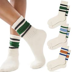 three pairs of white socks with multi - colored striped socks on the bottom and below