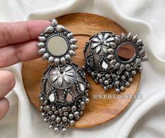 Add elegance and sophistication to any casual day with these silver-toned handcrafted Metal Jhumkies. It's a beautiful pair of handcrafted oxidized silver metal alloy jhumki embellished with Ghungroo and Mirrors. Base Metal- Alloy, Silver, Brass Plating- German Silver Stone- Mirror Sizing-Non Adjustable Type- Jhumka Earring Light Weight Recycled Item Skin Friendly- Lead & Nickel Free in compliance with all International Requirements. Gift - Ideal Valentine, Birthday, Anniversary gift for someone Mirror Jhumka, Oxidised Jhumka, Silver Jhumkas, Stone Mirror, Indian Women Fashion, Oversized Earrings, Fancy Jewellery Designs, Silver Jewellery Indian, Indian Jewelry Sets