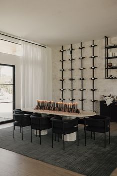 a living room filled with furniture and a fire place next to a wall mounted book shelf