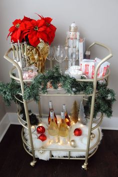 a bar cart with christmas decorations and wine bottles