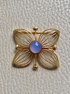 1951 Modernist Four Petal Flower Brooch with Chalcedony Stone in 18k gold - Stockholm, Sweden by Stigbert A wonderful well-sized and graphic 4-petal flower brooch by the Modernist master, Stig Engelbert. Each petal is formed as if the lines from his sketch book just popped into form around a perfect mystical periwinkle chalcedony cabochon. It looks a bit like a crystal ball, yes? This brooch was made in 1951 by maker Stigbert for Engelbert Heribert in Stockholm, Sweden. Piece measures about 1.5 Mid-century Cabochon Brooch For Gift, Four Petal Flower, Vintage Gold Necklace, Chalcedony Stone, Petal Flower, Stockholm Sweden, Pin Backs, Gold Flowers, Flower Brooch