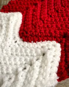 two red and white crocheted dishcloths laying on top of each other