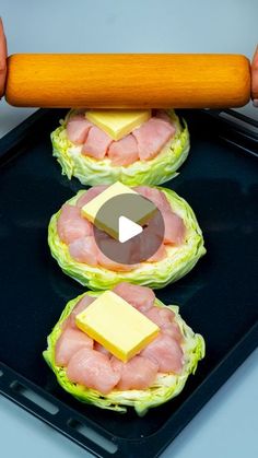 three lettuce cups with ham and cheese on them being held by two hands