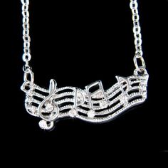 PERFECT GIFT FOR MUSIC FANS, INSTRUCTOR, TEACHER OR STUDENT!!Great Gift for Bride who are musician.This sparkling Crystals TREBLE CLEF music melody pendant with Swarovski crystals measuring 1 1/16"  (27mm) wide X 7/16"  (6mm) high. It comes with a FREE 16.5" inch (41.7cm) rhodium plated fine cable chain necklace with lobster clasp (plus 2" extender chain). Crystal Color: Crystal ClearGreat piece for your collection!===================Prices are in US$.For shipping policies and other important in Holiday Party Silver Necklaces, Holiday Party Silver Necklace, Silver Necklace Party Gift, Silver Necklace For Party Or Gift, Silver Necklace For Party And Gift, Silver Necklace For Party Or As A Gift, Silver Music-themed Jewelry For Party, Music-themed Silver Jewelry For Parties, Musical Jewelry