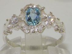 "*This ring is made from 925 Sterling Silver with Genuine Natural Aquamarine & Cubic Zirconias . This stunning ring has been set with a center 6x4mm (0.24\" x 0.16\") Aquamarine and two Sparkling White Cubic Zirconias on the shoulders measuring 2.25mm (0.09\").  The contrast of the Vibrant Blue Aquamarine with these Sparkling Cubic Zirconia's set within this delicate yet strong setting, creates such an elegant look and feel, this ring is certainly a very special piece. The design is such that it has a dainty appearance yet the large central stone is very vivid and eye-catching, therefore it is a beautiful ring to wear comfortable, noticeable yet not overpowering. PLEASE MAKE SURE YOU STATE THE FINGER SIZE YOU REQUIRE WITH YOUR PAYMENT AND PROVIDE YOUR TELEPHONE NUMBER FOR DELIVERY COURIER. Pave Ring, Aquamarine Blue, Natural Aquamarine, Delicate Rings, Dream Jewelry, Pretty Jewellery, Sparkle Diamonds, Victorian Style, Promise Ring