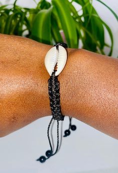 This braided cowrie bracelet is like a little slice of vacation that you can wear on your wrist! Cowrie shells are paired with a cool, adjustable cord that fits whatever adventure you have in mind. Whether you're on the beach, in the city, or just in lounging mode, this bracelet gives you that laid-back, boho vibe that makes every day feel like a lazy day in the sun. So, treat yourself and add some of that summer feeling to your style! Cowrie Bracelet, Cowrie Shell Bracelet, Cowrie Shells, Shell Bracelet, Lazy Day, Cowrie Shell, Summer Feeling, Boho Vibe, Charm Bracelets