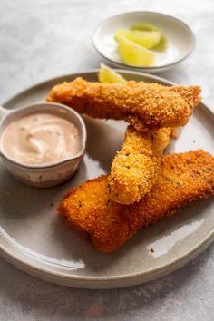 fried fish sticks on a plate with dipping sauce