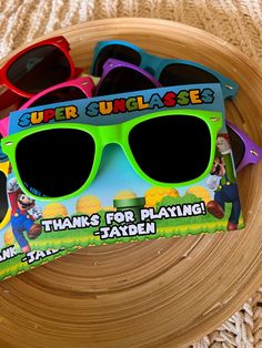 some sunglasses are sitting on top of a wooden plate with the words super suplasee