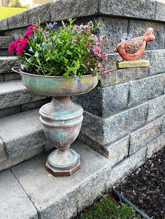 a planter filled with flowers sitting on top of steps