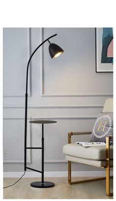 a black floor lamp next to a white chair