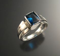 "This is a large beautifully cut deep blue Topaz. It is expertly faceted in an 8x10mm rectangular scissors cut. The stone is bezel-set in sterling Silver with wide tapered band with raised center. The pictured ring is size 10 for scale reference. I can make this ring in any size between 6 and 12. Please specify your ring size in a \"note to seller\" at check-out." Modest Beauty, Mans Ring, Pink Gold Rings, Hammered Hoop Earrings, London Blue Topaz Ring, Large Stone, Perfect Engagement Ring, London Blue Topaz, Blue Topaz Ring