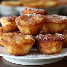 some sugared pastries are on a white plate